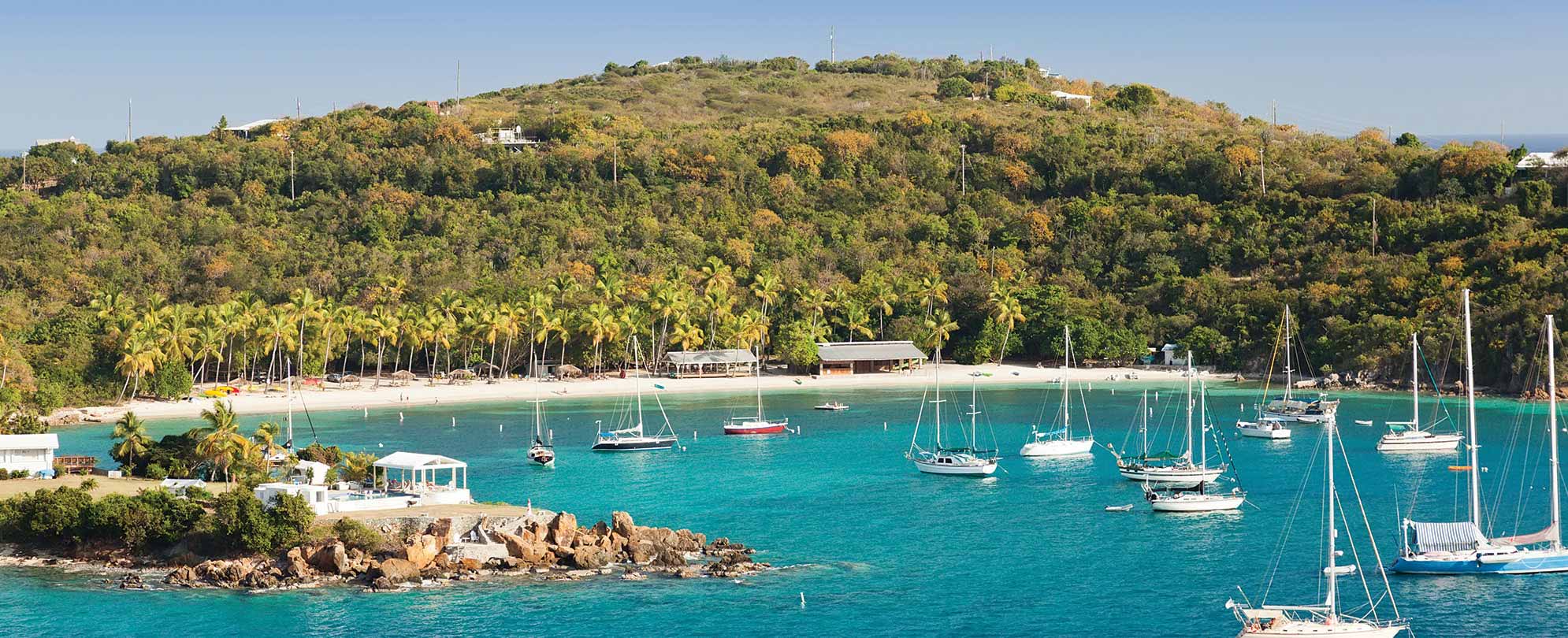 Several sailboats anchor in the bay while on vacation at Virgin Islands National Park in St. John